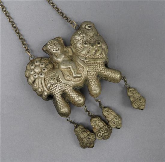 A white metal Chinese pendant on chain